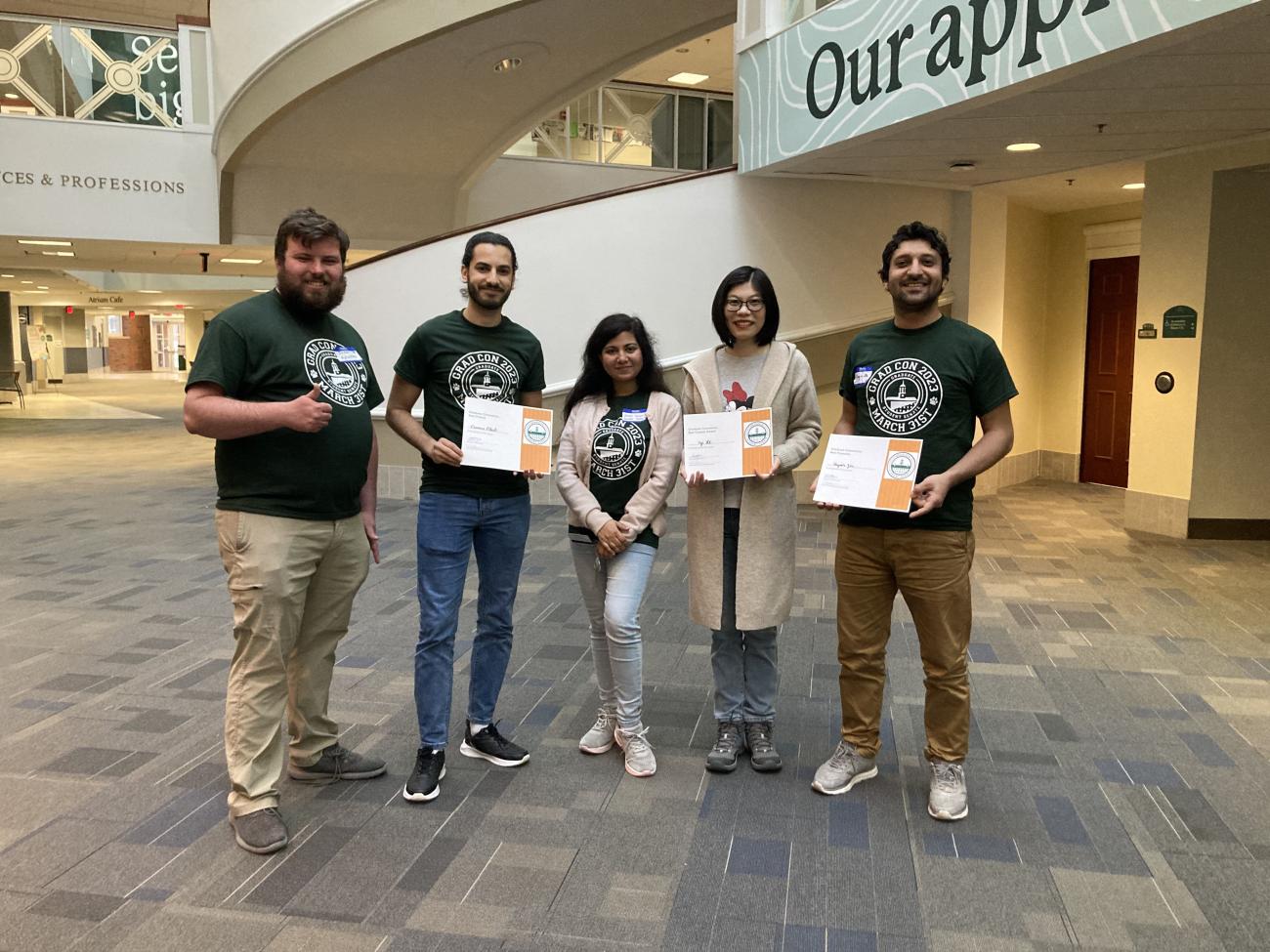 Four students pose at GSS GradCon