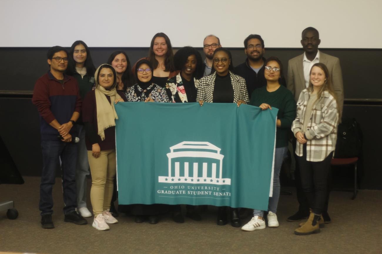 GSS team holding a banner