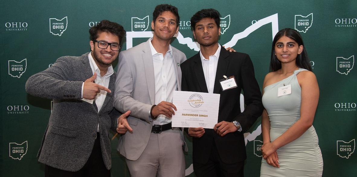 students holding their leadership award certificates