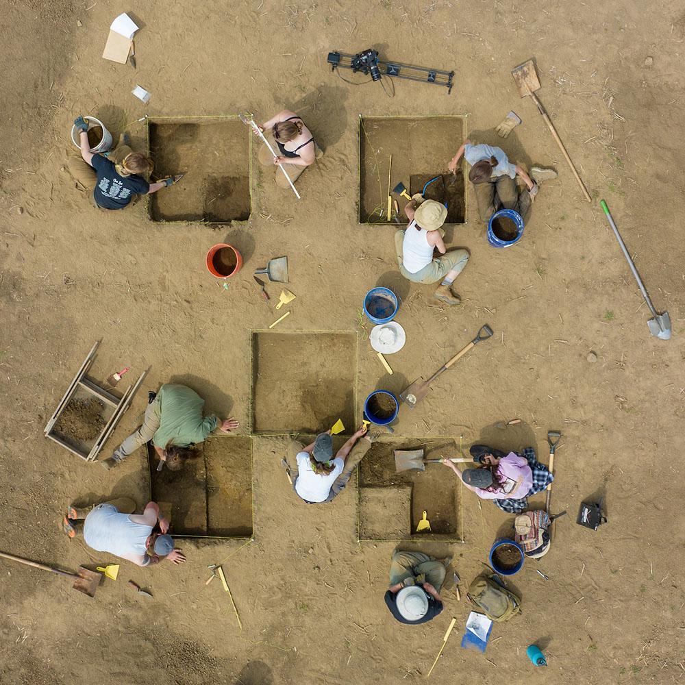 Aerial view of students working at an archeology field