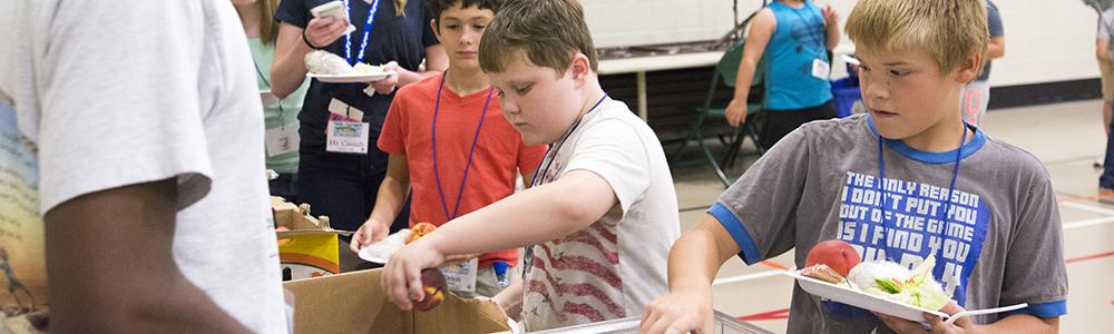 Kids receive food for lunch.