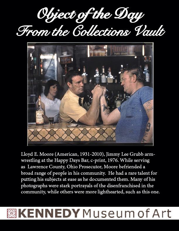 two men arm wrestling at a bar