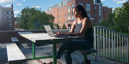 Student works at laptop