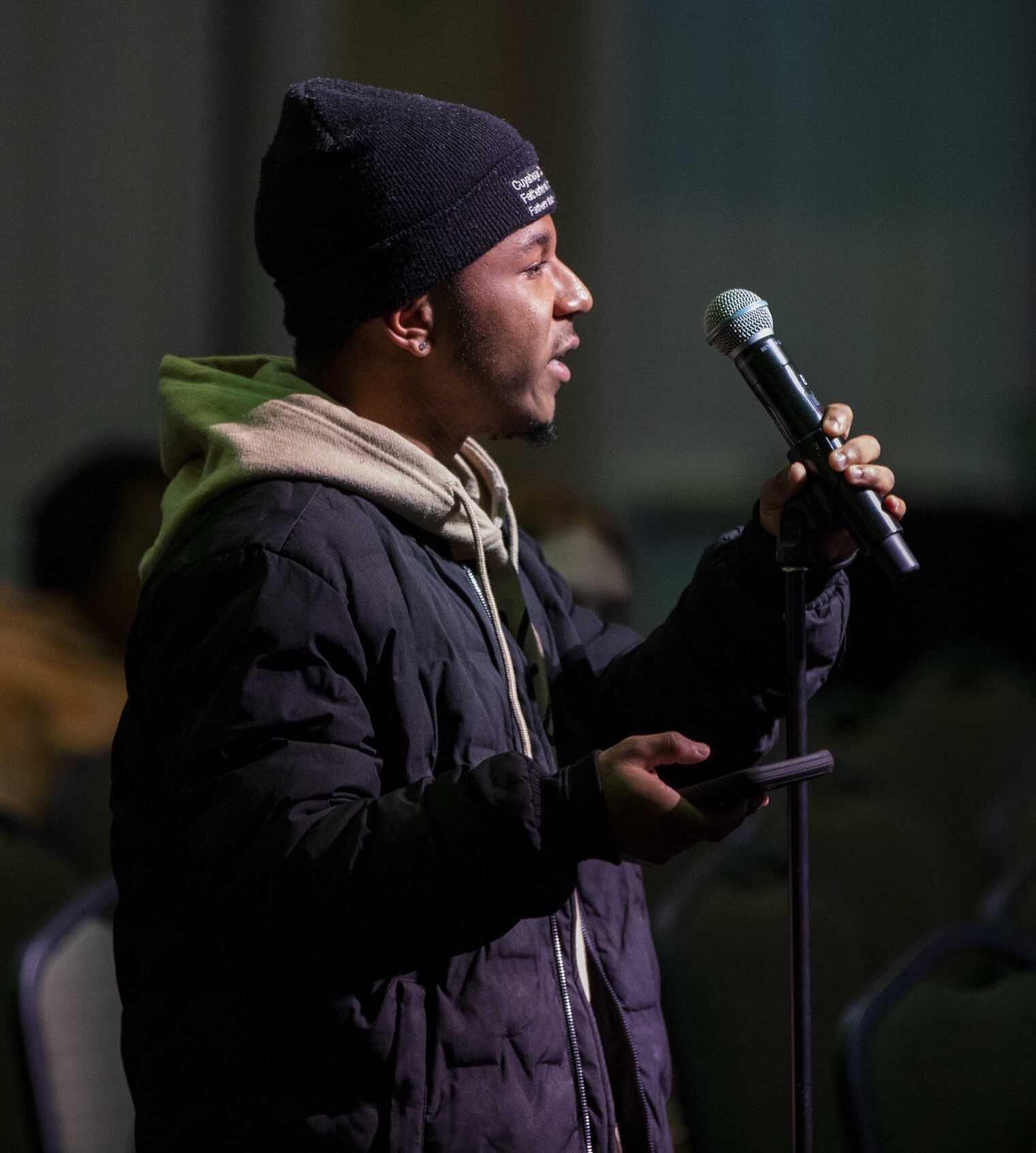 Student holding microphone asking a question