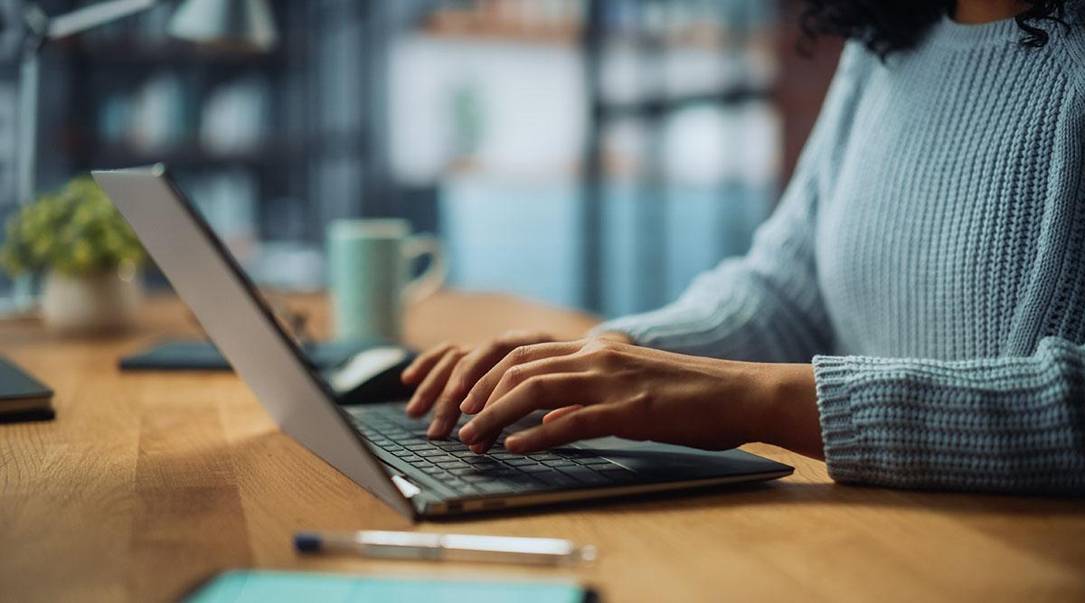 A person works at a laptop