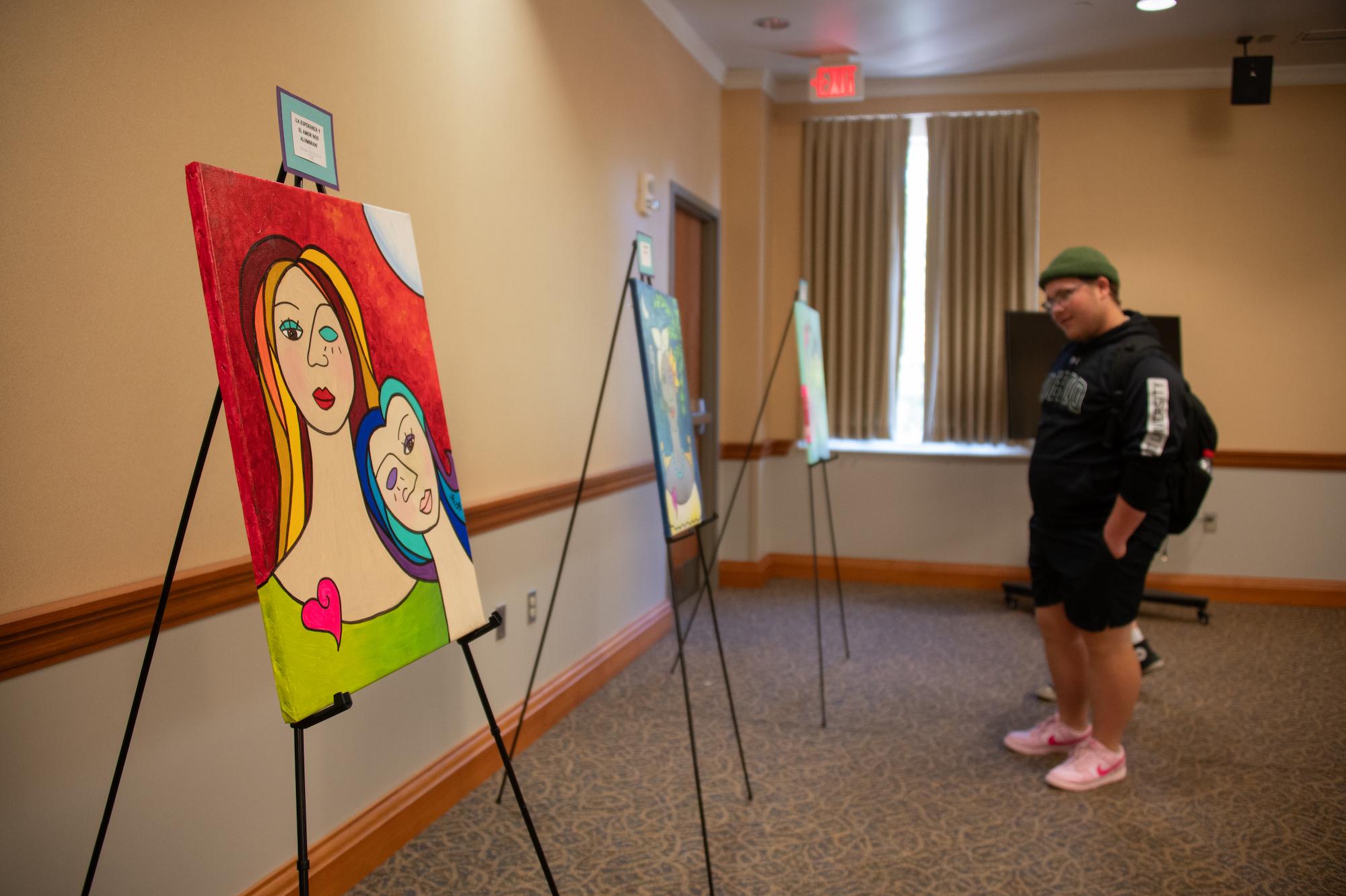 Student views the Hispanic Heritage Month art gallery opening 