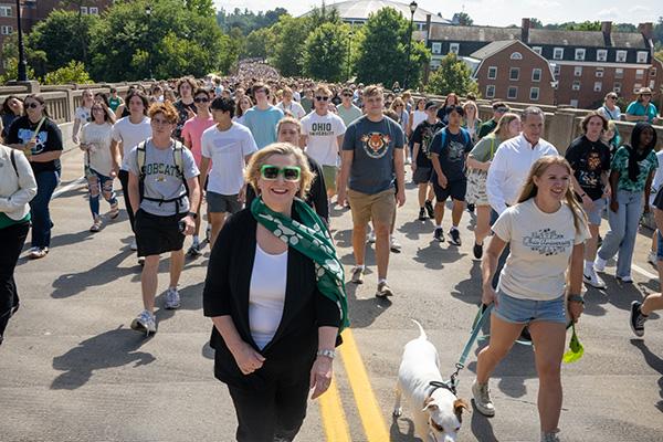 Ohio University President Lori Gonzalez leads students up Richland Ave to the Student Organization Involvement Fair.