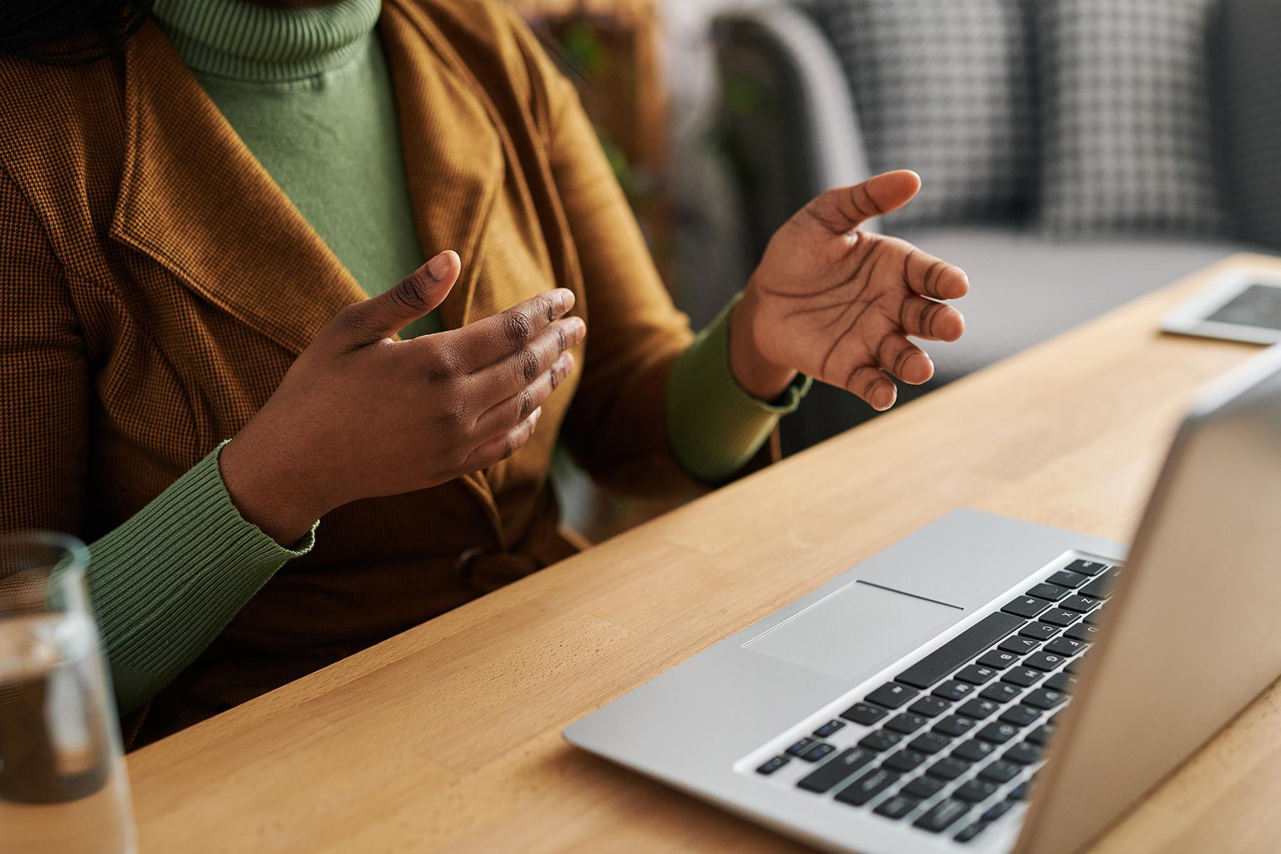 Woman talking to someone through a laptop