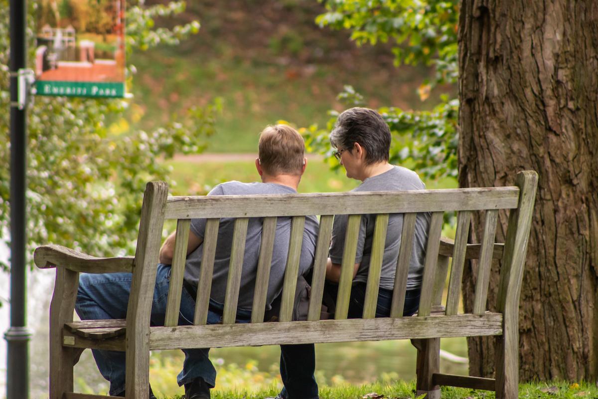 Parent and student sitting on bench