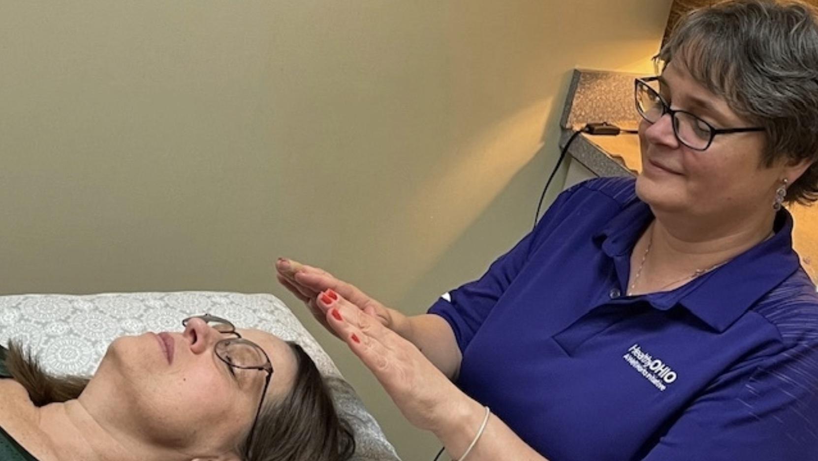 Louise Cruz performing reiki on client