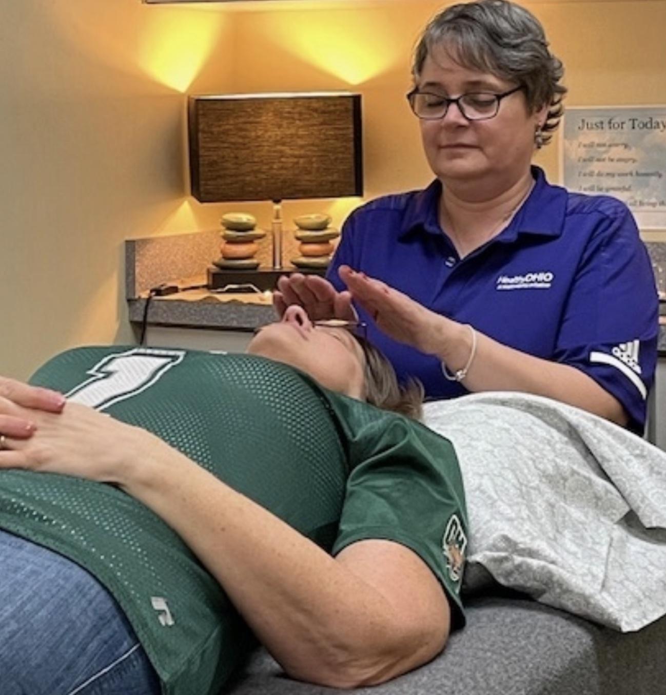 Louise Cruz performing reiki on client