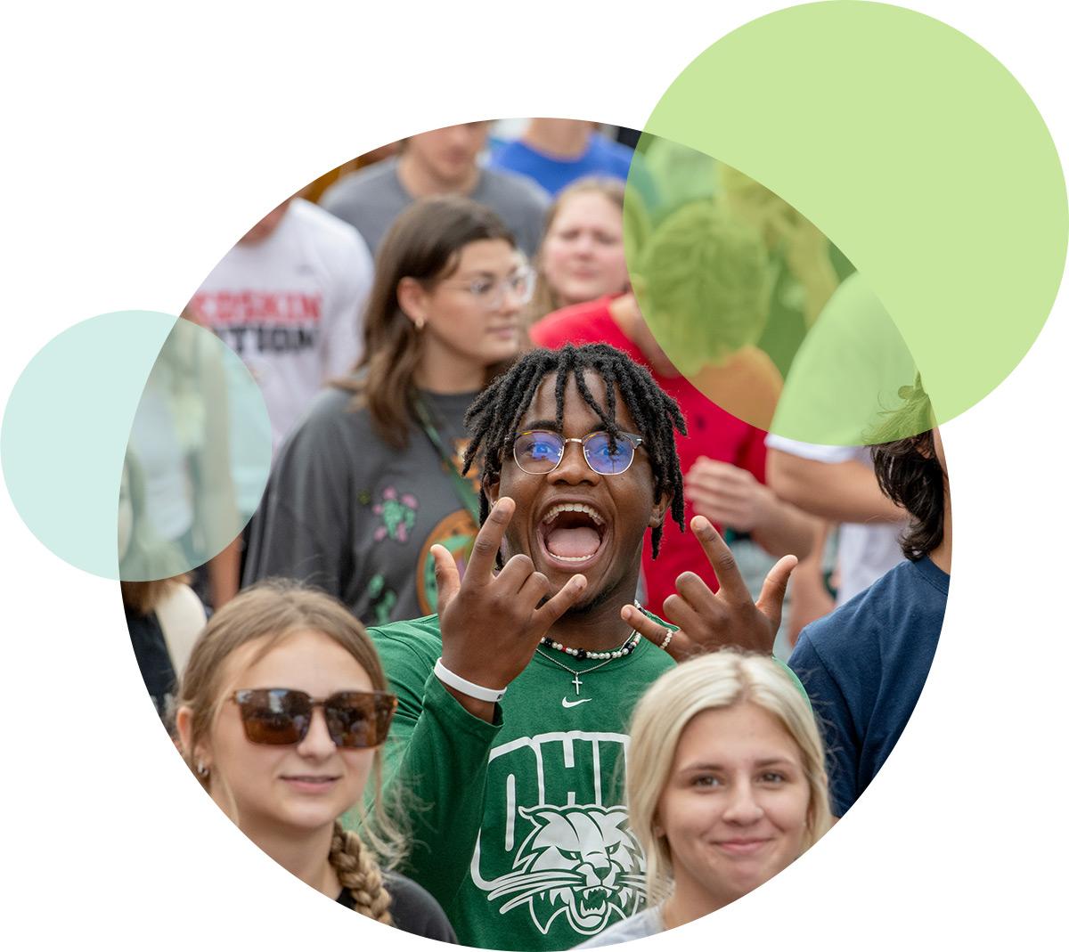 Students participating together at event with one student looking at camera and smiling