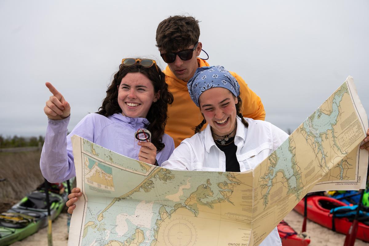Students look at a map for directions