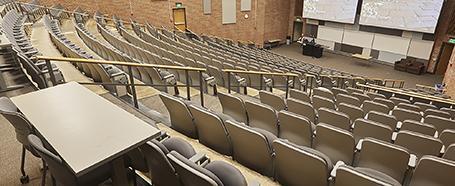 Inside a classroom in Morton Hall, featuring a tiered seating setup with a whiteboard at front of room