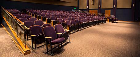 Seating inside Baker Theater, featuring padded cloth theater seating