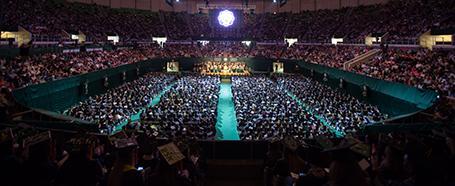 Inside the Convocation Center, full of students and families in chairs for Commencement ceremony