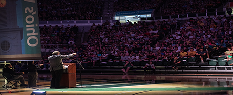 Inside the Convocation Center, featuring a speaker during Commencement ceremony