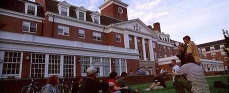 Exterior of Jefferson Hall, with students sitting in the grass outside