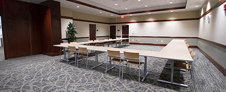 Conference room inside Nelson Commons, featuring tables in a U shape and chairs