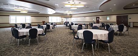 Inside Nelson Commons, set up with round tables and chairs for an event