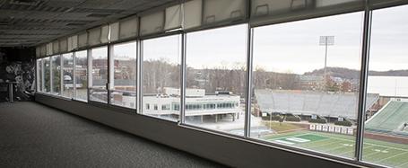 A room inside Sook Center, with a glass wall looking out onto the football field at Peden Stadium