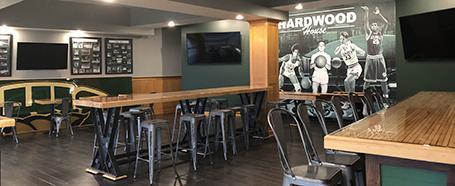 Inside Hardwood House restaurant, featuring tables and seating and bars and stools