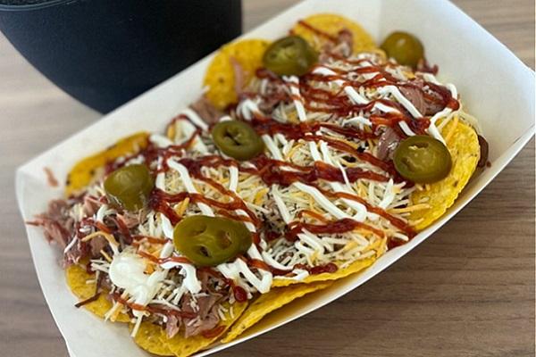 pulled pork nachos in a paper basket
