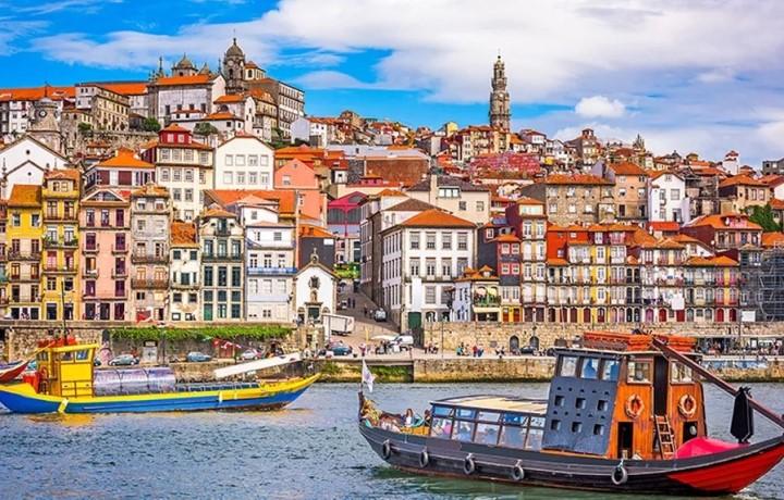 Portugal skyline with boat in harbor and colorful buildings.