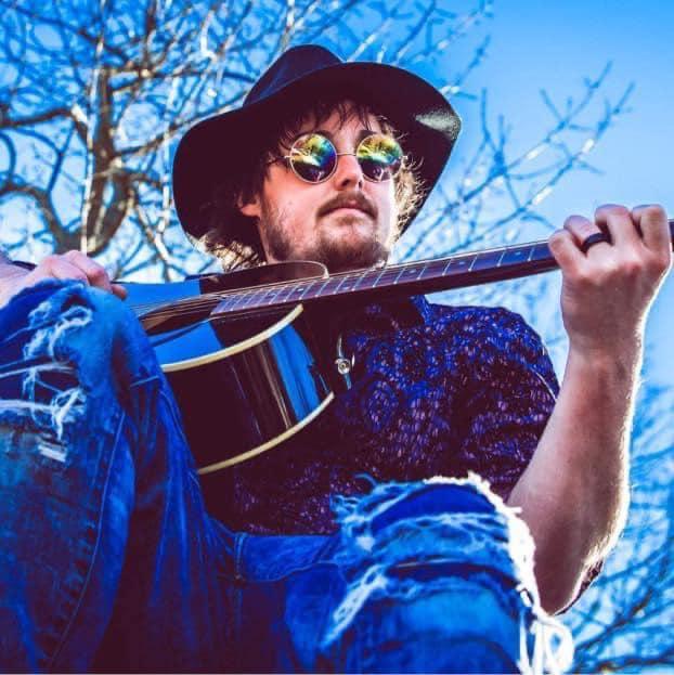 Man in sunglasses with acoustic guitar