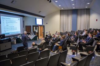 People in a lecture hall watching a presenter