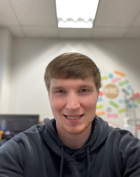 Staff member Matthew smiling for the camera
