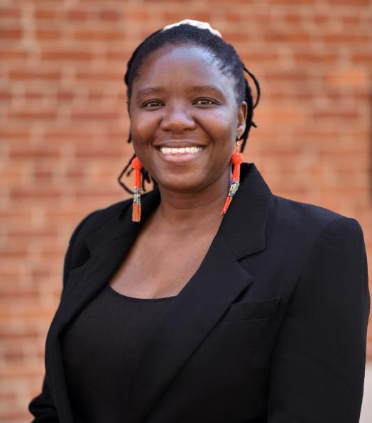 Bose Maposa wearing a black top and a black jacket