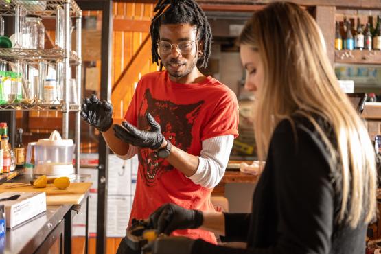 Two people working on brewing.