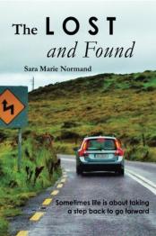 Green hills in background and car traveling on a road.