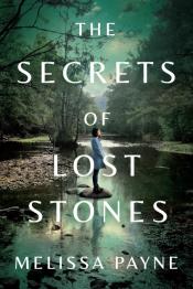 Person standing on stone in creek.