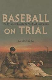 Baseball players from the past, one sliding into a base and other reaching down to tag.