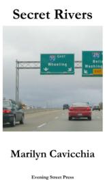 Cars on highway with signs overhead indicating 70 West towards Wheeling.