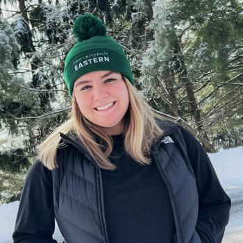 Student Lacey Cordery stands outside in the snow
