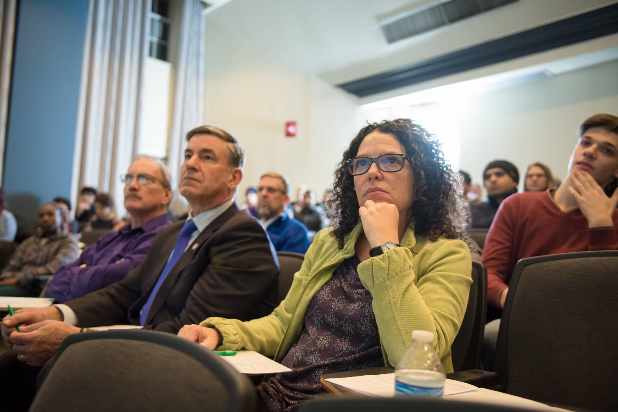 Faculty, staff and community members listen to Three Minute Thesis presentations at Stocker Center.