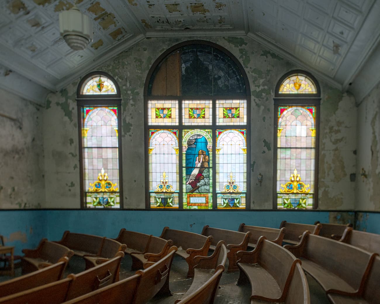 View of an ornate stained glass window from within Mount Zion Baptist Church