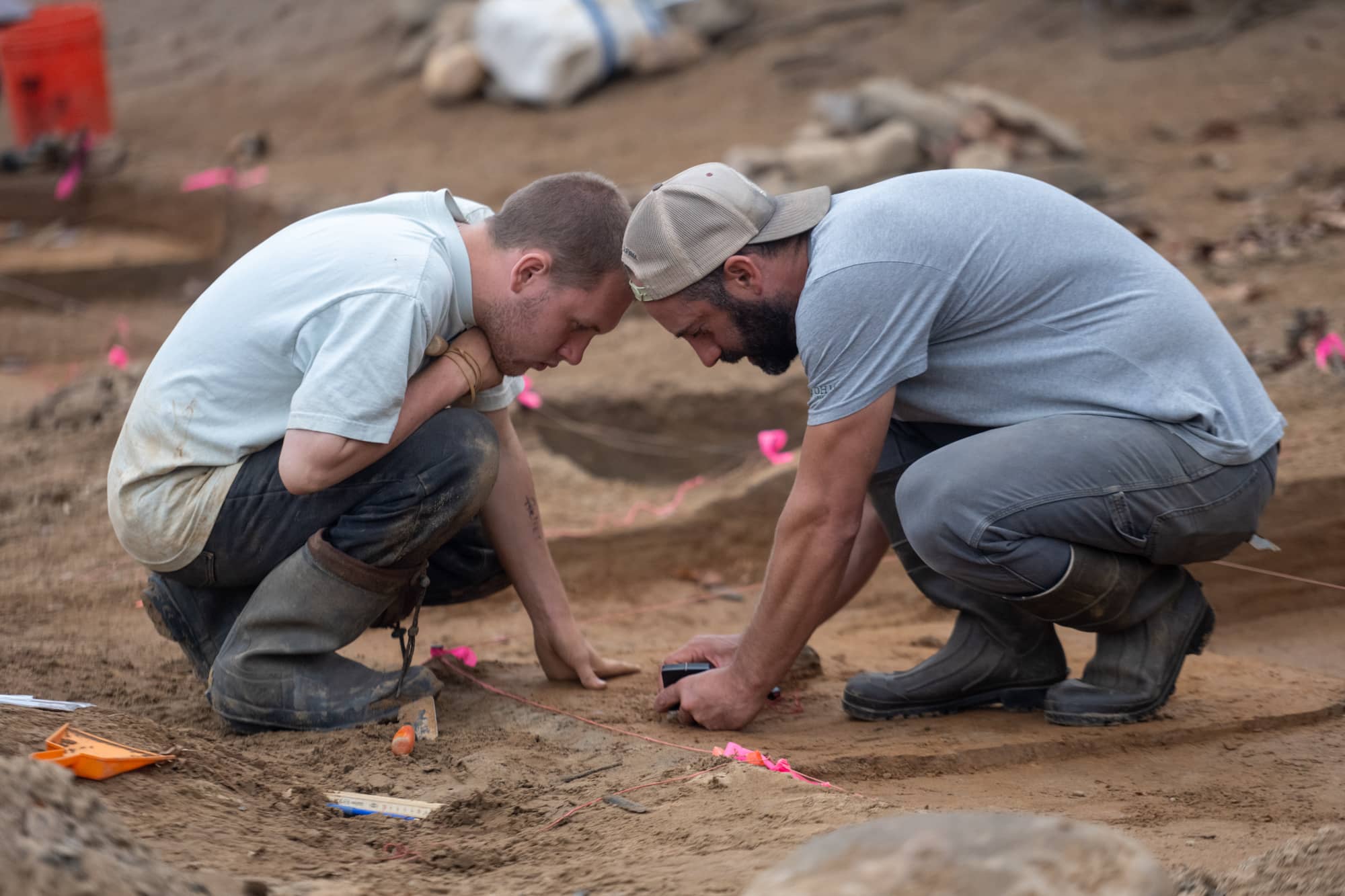 Joseph Gingerich, Ph.D., teaches student Hunter Arnett how to map artifacts.