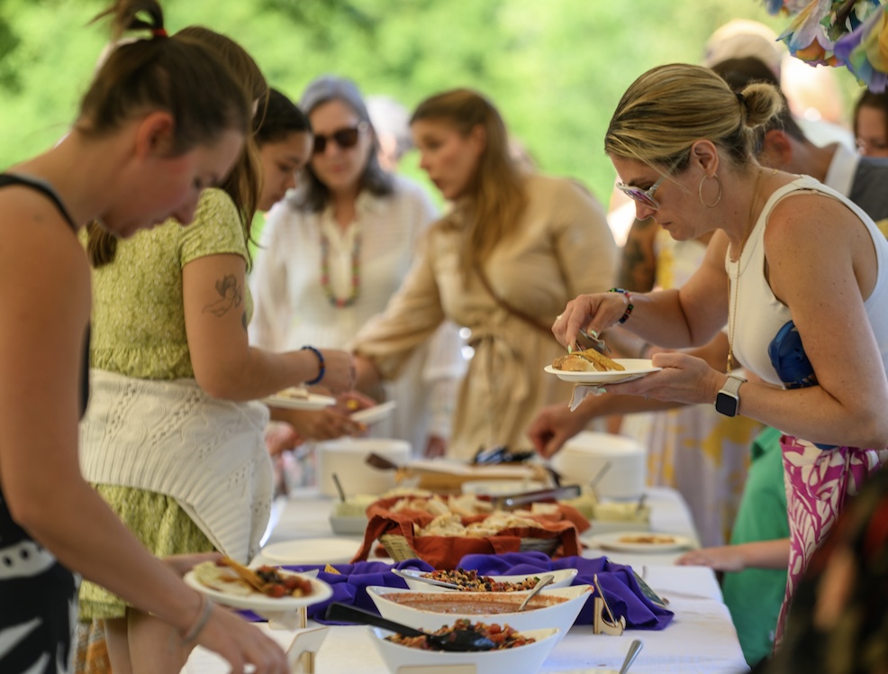 People gather to put food on their plates