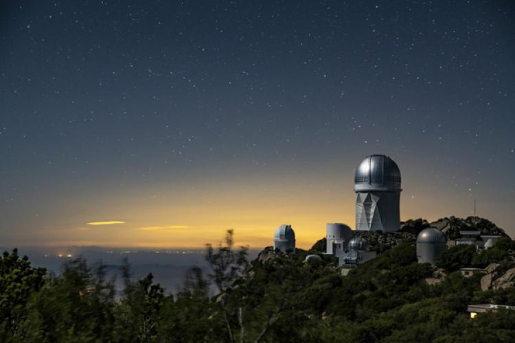 The Mayall 4-Meter Telescope, home to the Dark Energy Spectroscopic Instrument (DESI), seen at night at Kitt Peak National Observatory.