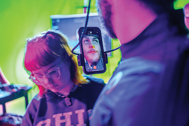 Young man works with facial recognition software. 