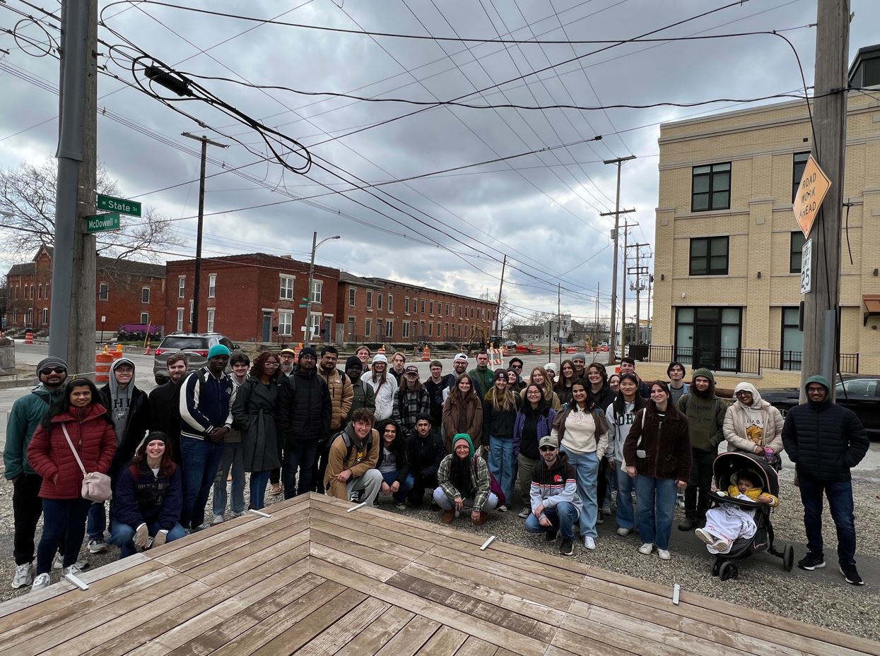 The 43 students + group leaders all in a group photo together in the city.