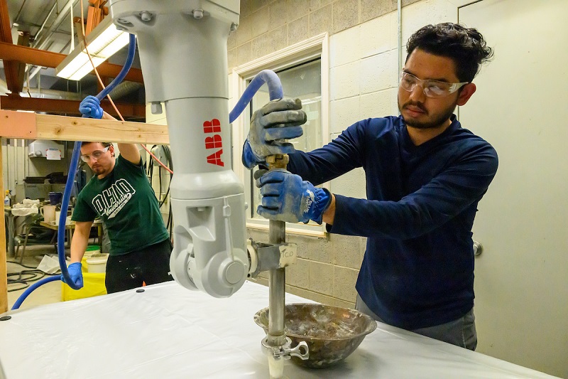 OHIO students work with a concrete printer in the 罗斯研究机会中心