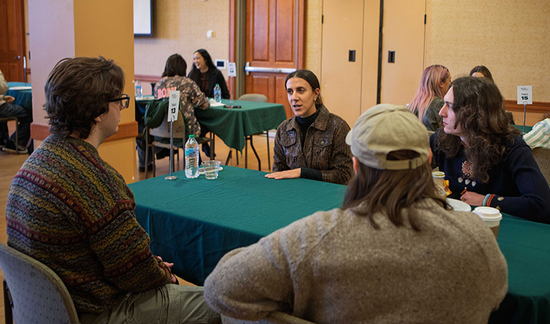 Booking and management coordinator Mads Murphy speaks with Music Industry Summit attendees at a mentoring roundtable.