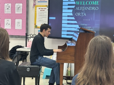 Alejandro Orta is pictured sitting at a piano
