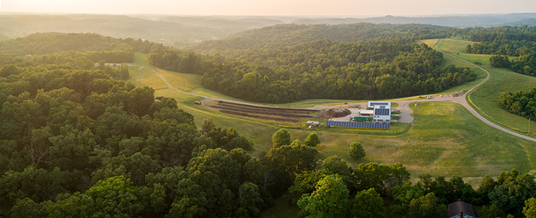 The Compost Facility is surrounded by lush greenery.