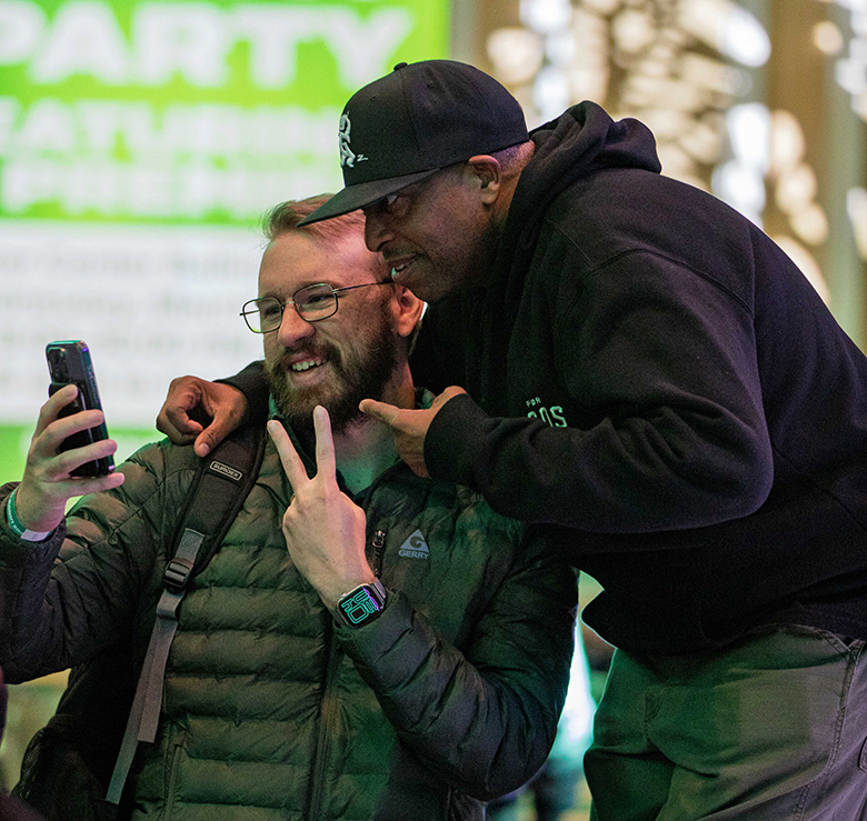 A Music Industry Summit attendee takes a selfie with DJ Premier.